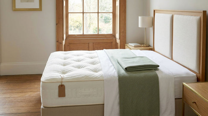 Hand-tufted cream mattress on a made bed in a calm British bedroom, Carter & Lewis Black Friday 2026