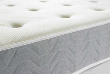 Memory Collection mattress edge showing the charcoal wave-quilted border and tufted top