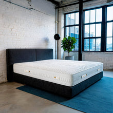 Carter & Lewis IceCool cooling mattress on a charcoal platform bed in a converted industrial loft bedroom