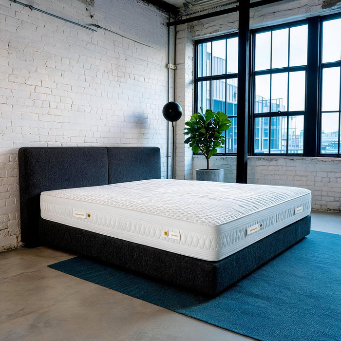Carter & Lewis IceCool cooling mattress on a charcoal platform bed in a converted industrial loft bedroom