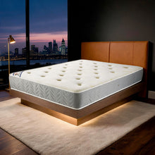 Carter & Lewis Memory Ortho mattress with grey border on a tan leather bed in a London apartment at dusk