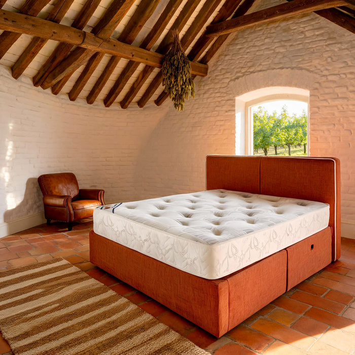 Carter & Lewis Memory Plus Pocket mattress on a terracotta ottoman bed in a beamed English cottage bedroom